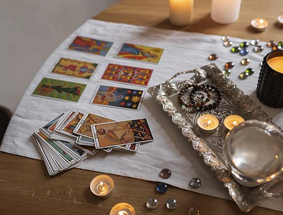 Carte oracles sur une table, avec divers objets ésothériques outils d'une séance de guidance