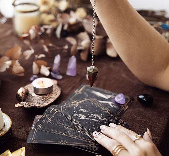 Pendule sur des cartes d'Oracles - Outil d'une séance de guidance, voyance